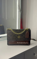 Dark brown purse with gold strap