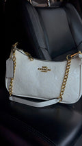 White purse with gold straps