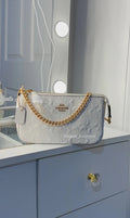 White monogram purse with rose gold straps