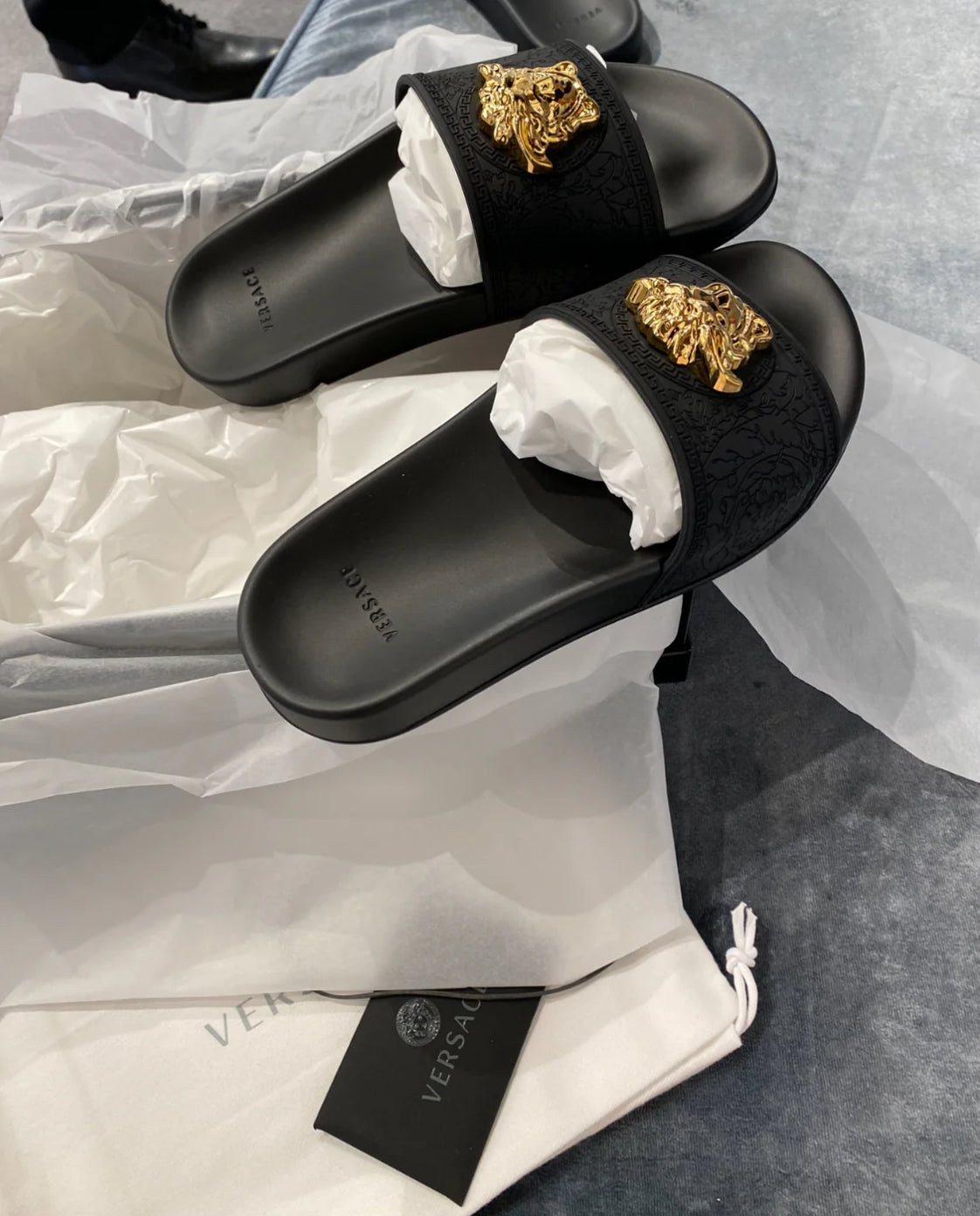 Woman’s black & gold slides