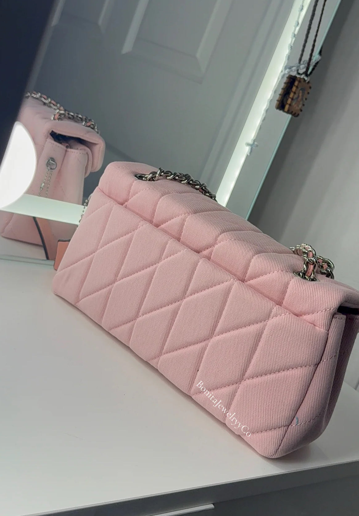 Pink cross body purse with silver wear