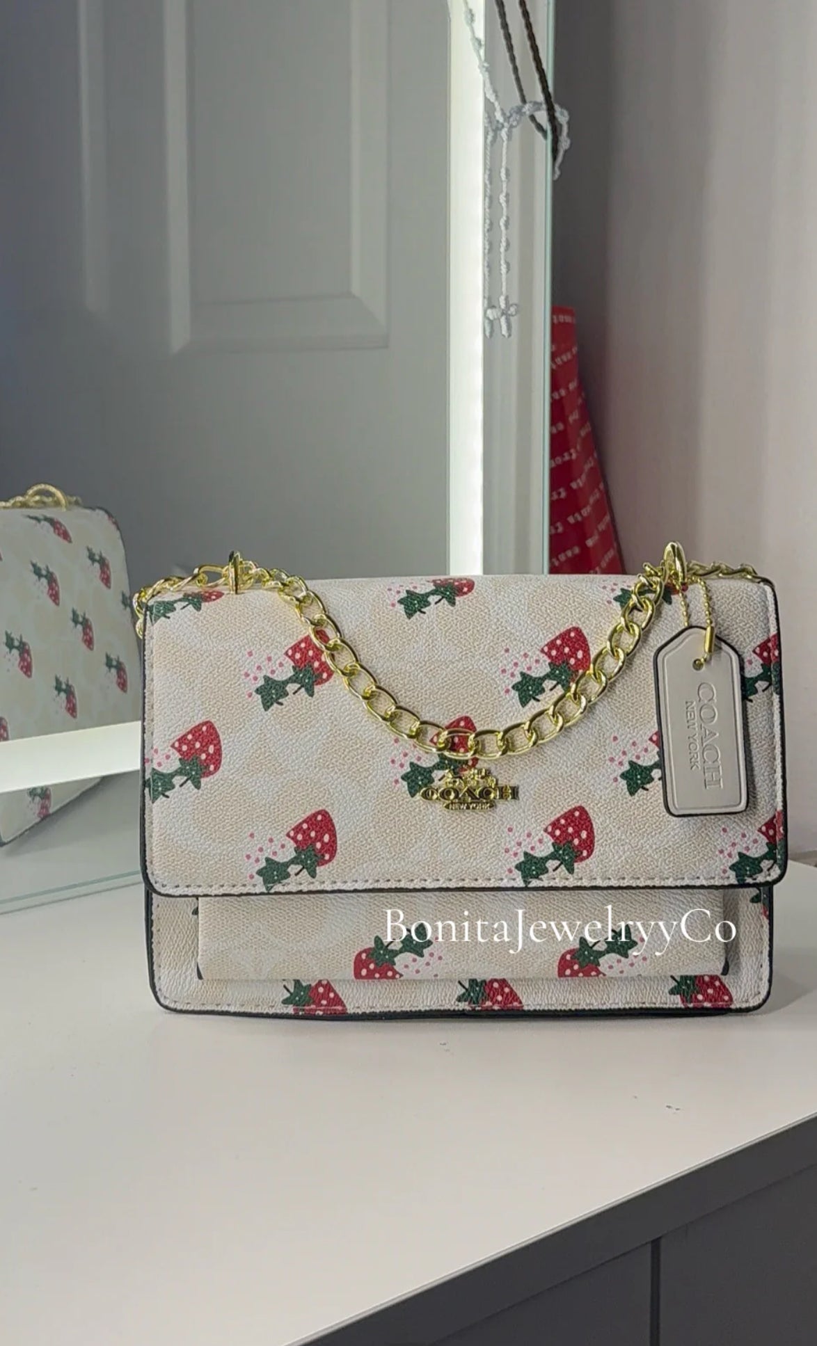White strawberry purse with gold strap
