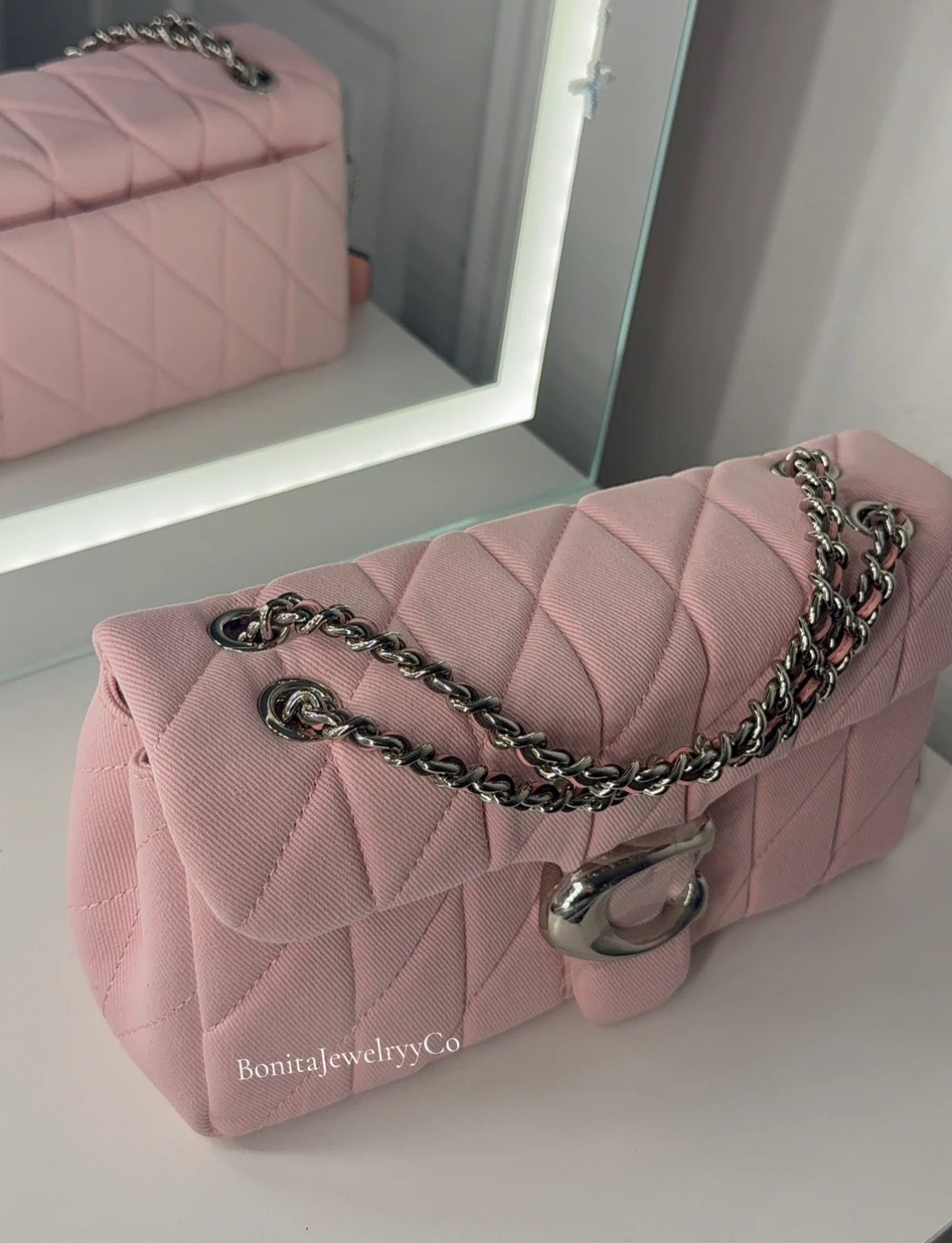 Pink cross body purse with silver wear