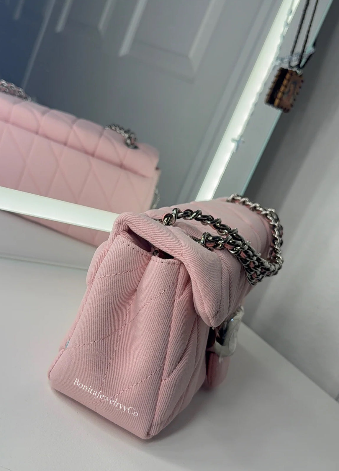 Pink cross body purse with silver wear