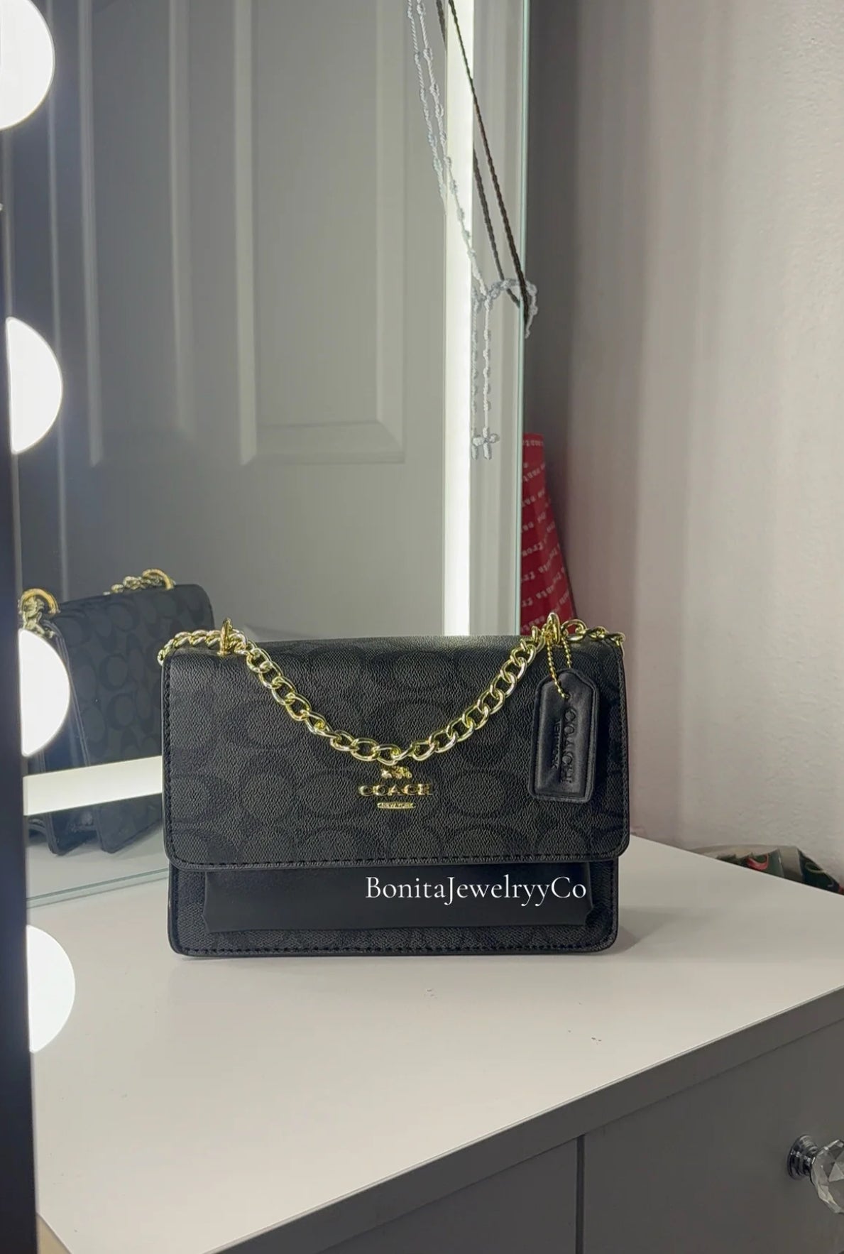 Black purse with gold strap